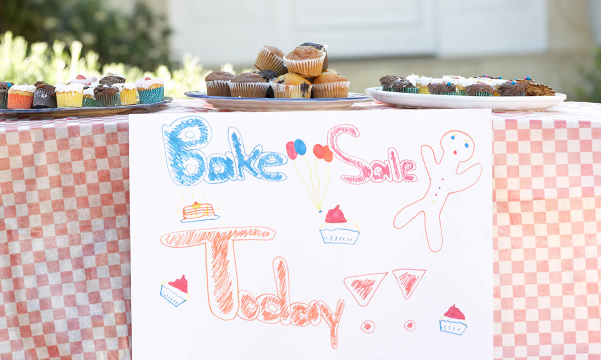 A table with cakes for a bake sale