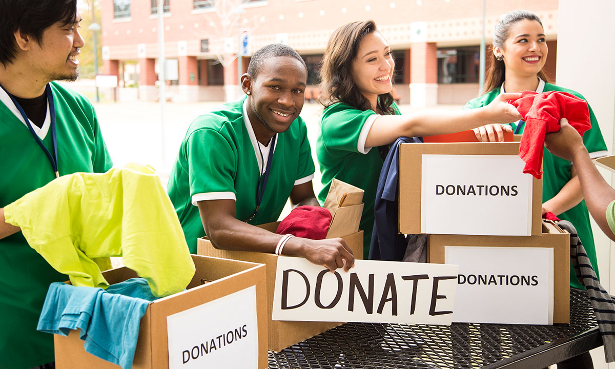 Teenagers holding cardboard boxes of donations workshop